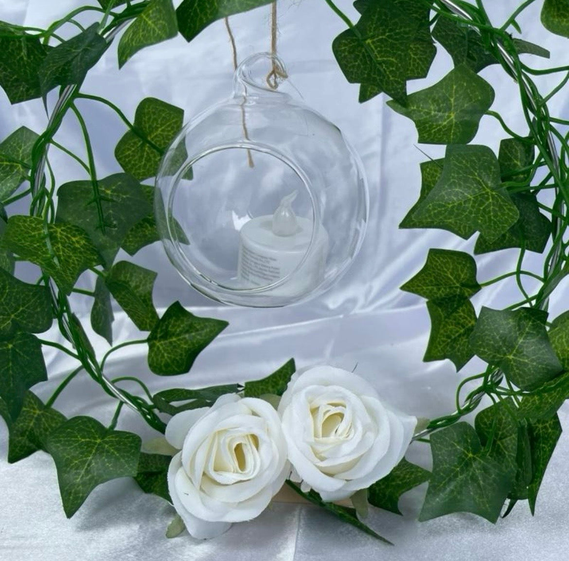 Metal Floral Centrepiece with Ivy white roses transparent hanging sphere and LED candle