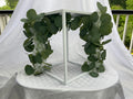 White Metal Square Wedding Stand with Eucalyptus and delicate white flowers