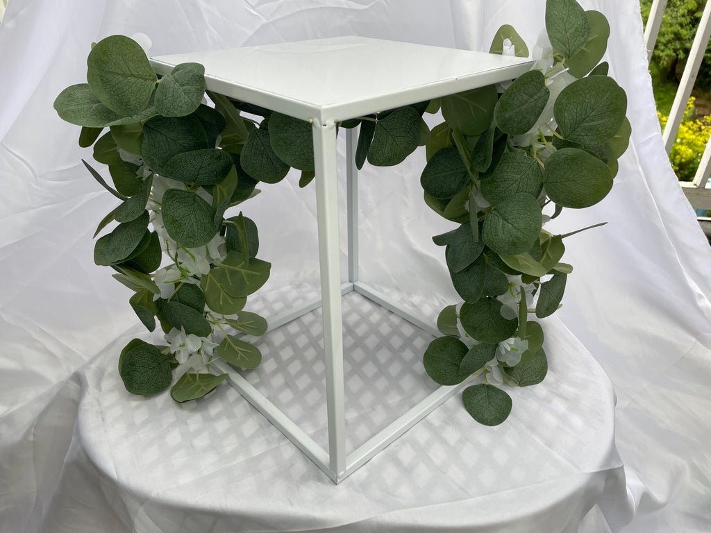 White Metal Square Wedding Stand with Eucalyptus and delicate white flowers