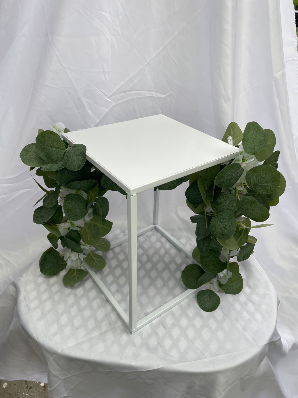 White Metal Square Wedding Stand with Eucalyptus and delicate white flowers
